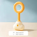 White blue dog pooper scooper with cloud-shaped jaw design on grass