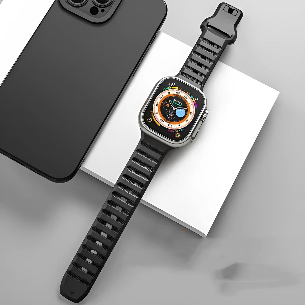 Fluoro rubber Apple Watch replacement strap with T buckle in one of six colours on a wrist.