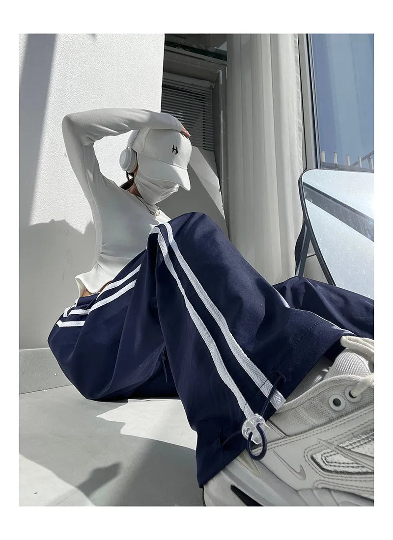 Women's loose straight-leg trousers with contrast ribbon parallel bars detail in navy blue