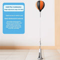 Vertical inflatable speed ball punching target with PU ball, boxing gloves and bandages on a wood floor for home training