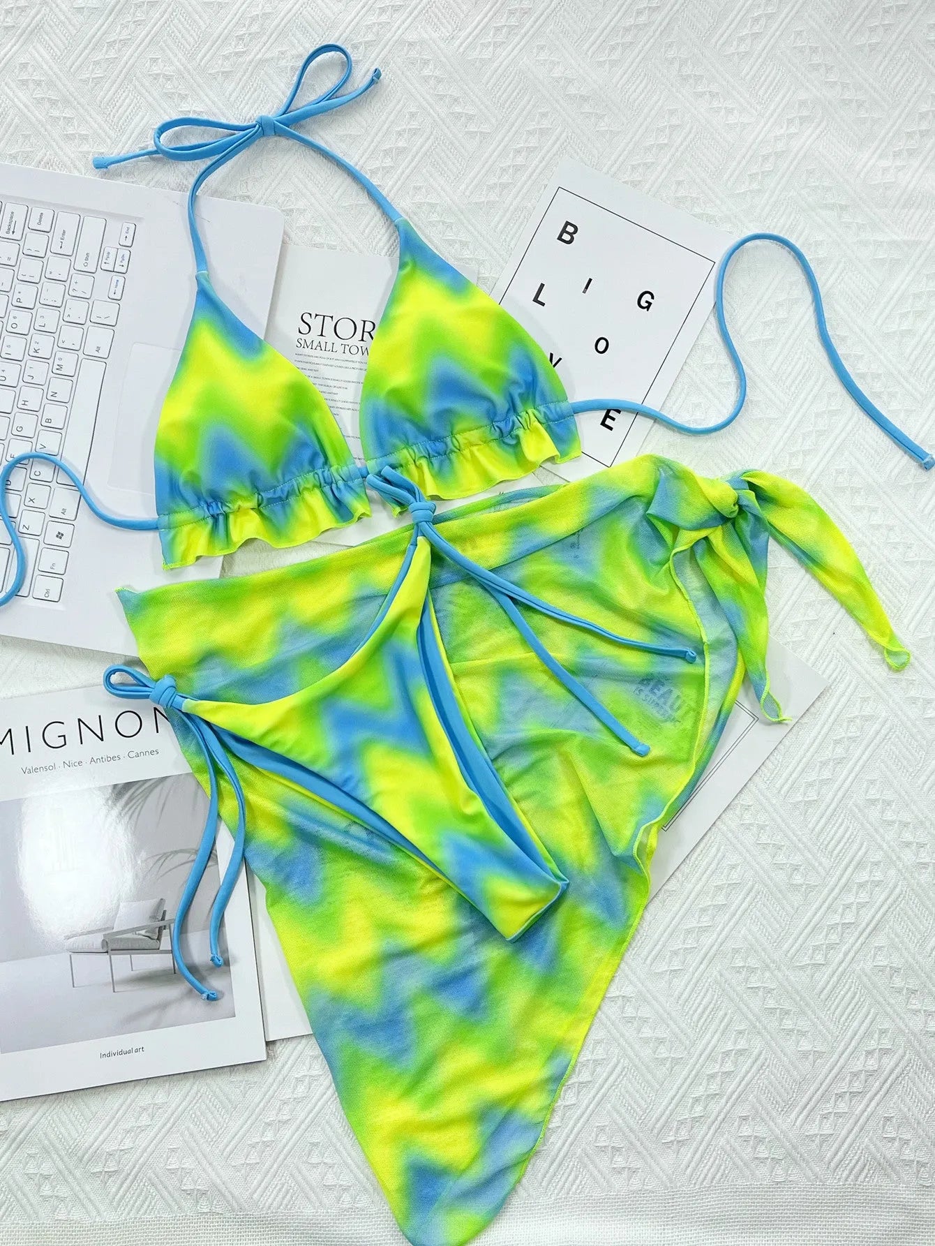 Green tie-dyed women's bikini swimsuit with detachable skirt on hanger