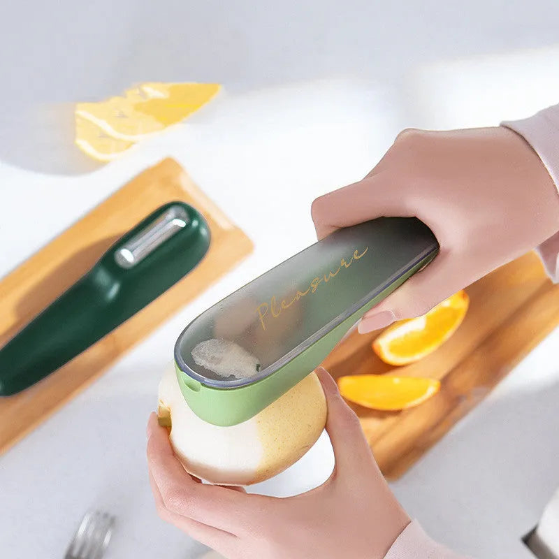 Dark green kitchen peeler with storage tube and stainless steel blade for fruit and vegetable peeling