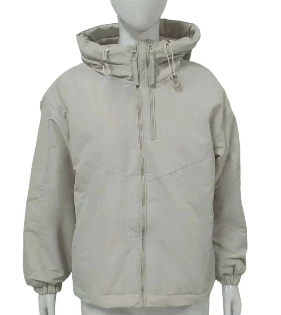 A woman wearing a loose-fitting grey hooded shell jacket with long sleeves, showing the front zip closure.