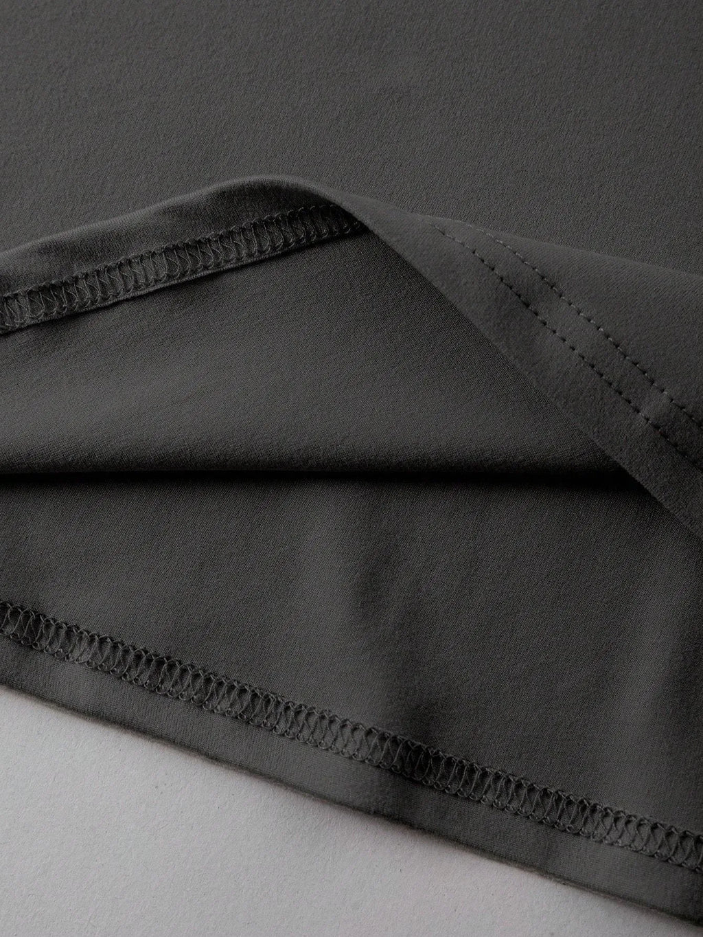 Loose fit cotton short sleeve t-shirt in black, shown on a hanger with round neck and straight cut.