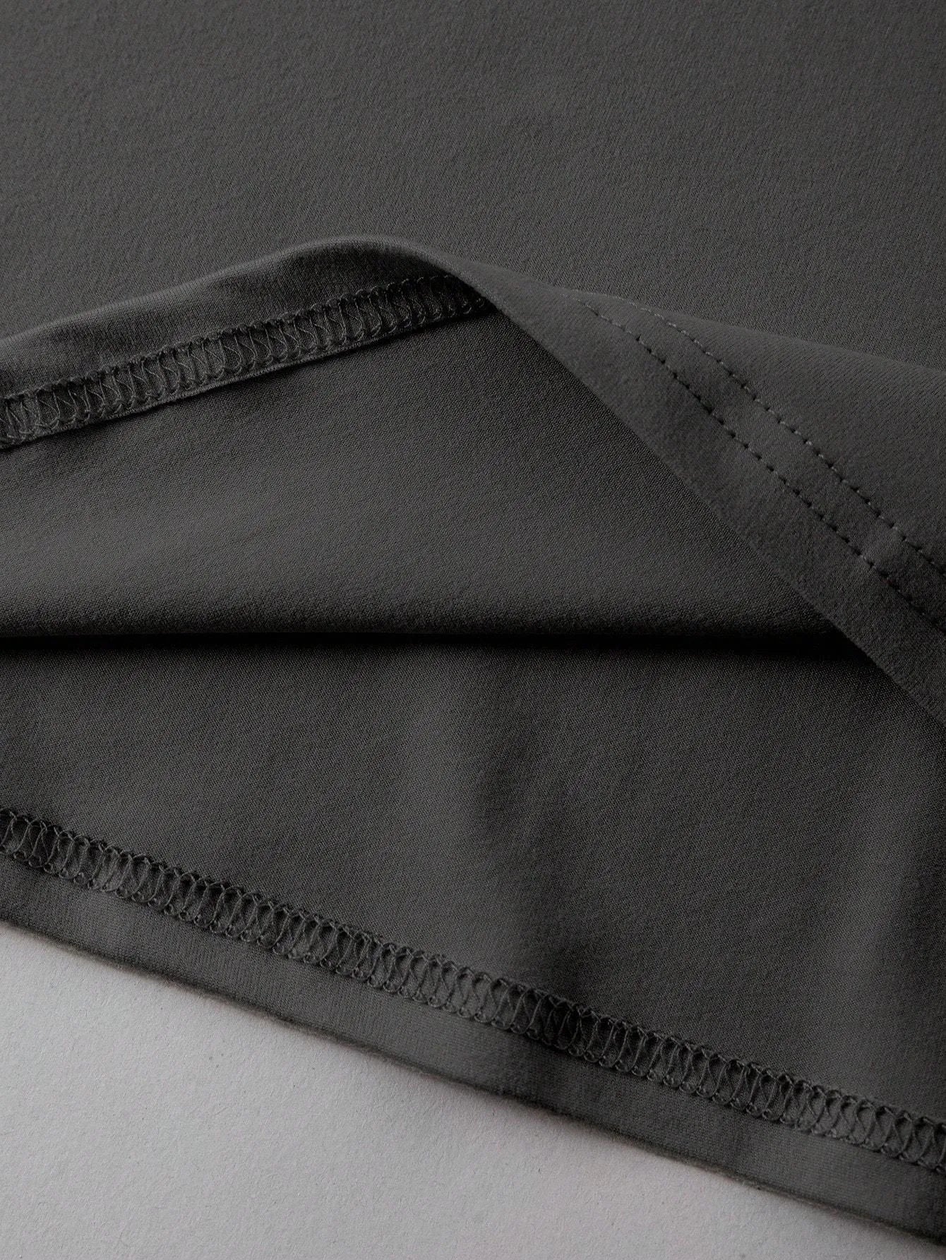 Loose fit cotton short sleeve t-shirt in black, shown on a hanger with round neck and straight cut.