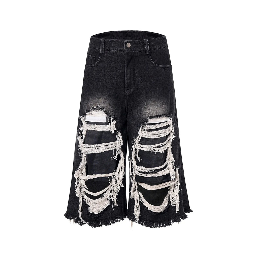 Black wide-leg cropped jeans with ripped patch details on a mid-high waist, loose fit.