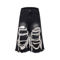 Black wide-leg cropped jeans with ripped patch details on a mid-high waist, loose fit.