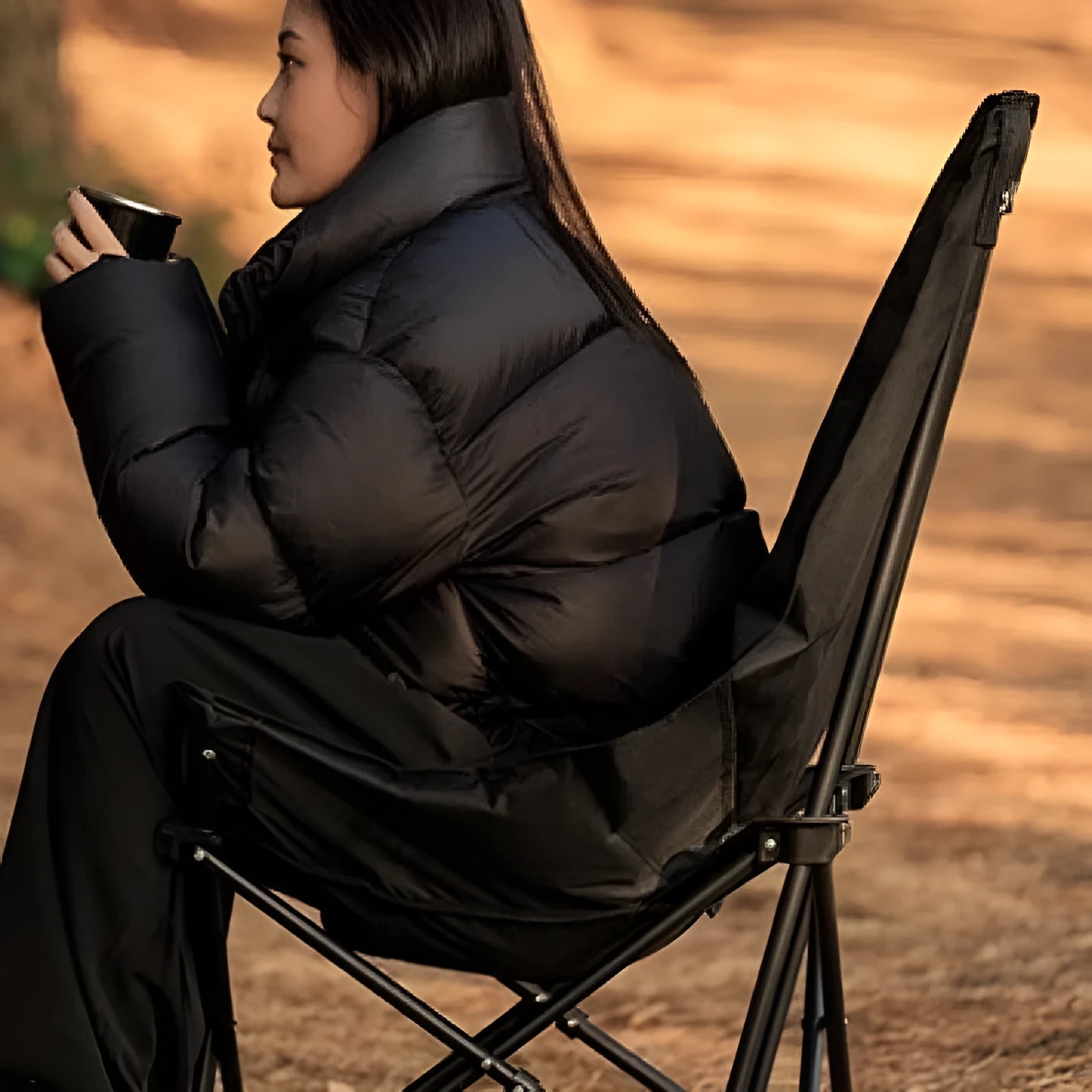 Night black Oxford cloth camping moon chair in folded position with carrying bag