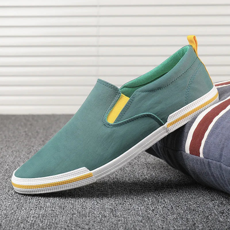 Men's low-top casual canvas shoes in grey, black orange, or khaki with vulcanised rubber soles.