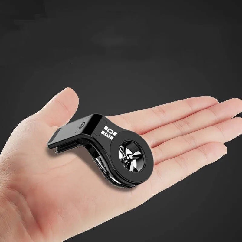 Magnetic car phone holder with fragrance diffuser clipped to car air vent