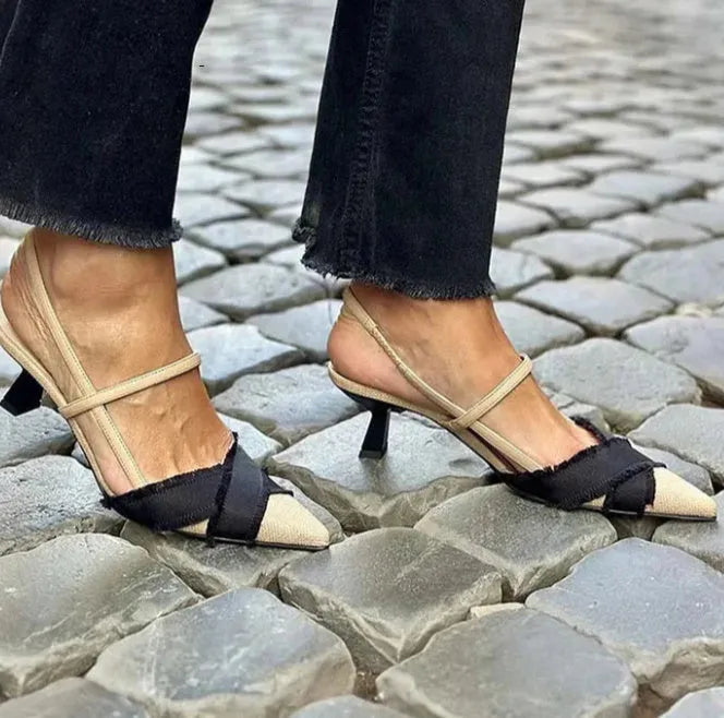 Apricot black women's stiletto heel sandals with pointed toe and buckle fastening on a rubber sole.