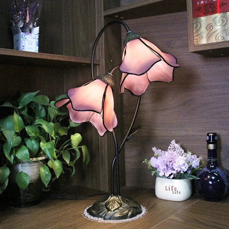 Retro American style desk lamp with lotus glass shade on wooden table.