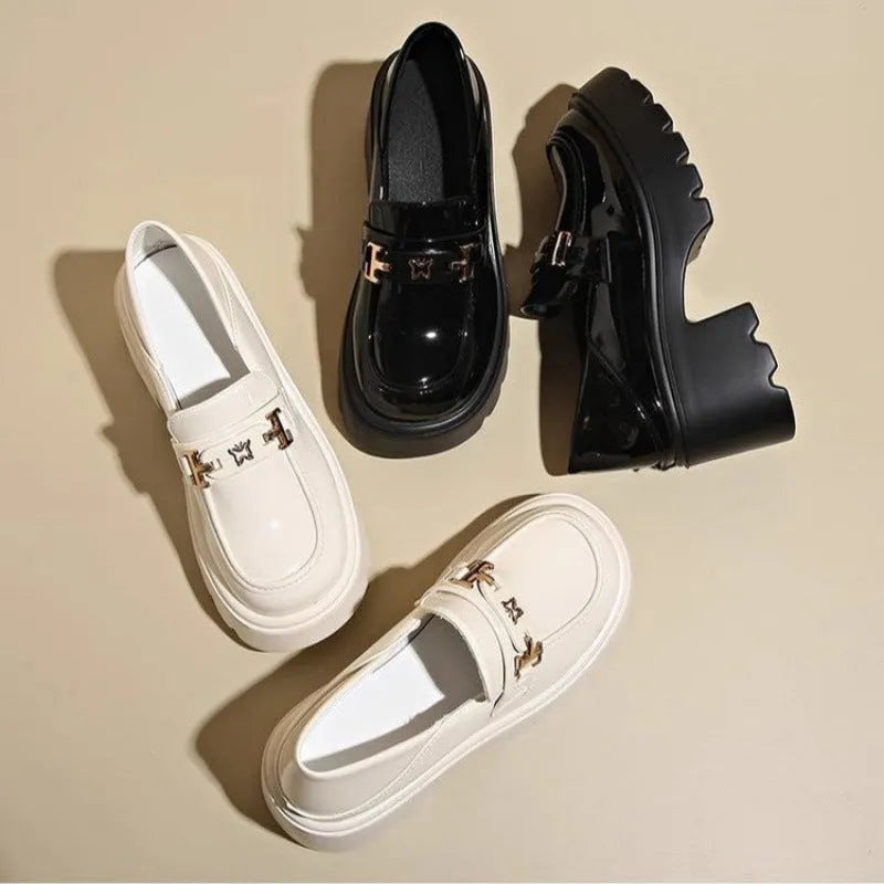 Slip-on chunky heel black leather shoes with skull pattern and square heel on a white background