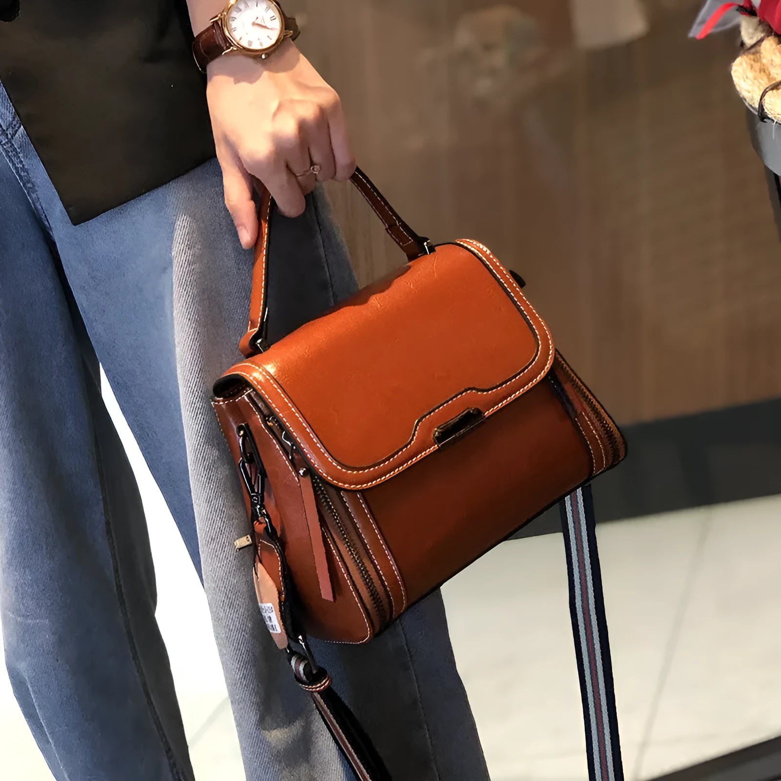 Women's brown genuine leather retro messenger bag with double strap and external pockets.