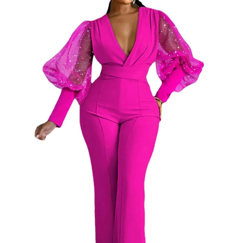 Red women's jumpsuit with mesh stitching on long sleeves, elastic waist, and wide-leg trousers on a model.