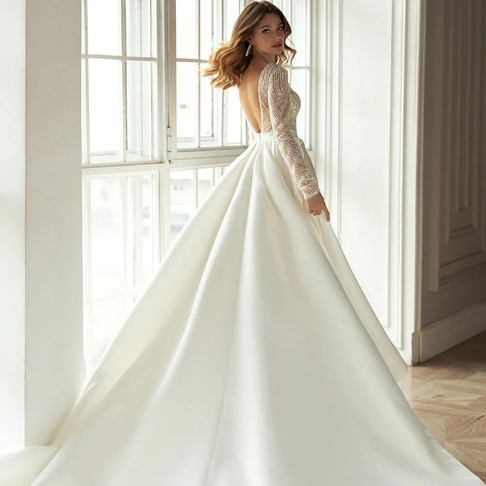 Women's white long sleeve hollow-out dress with gilded detailing, long skirt, and mid-waist cut