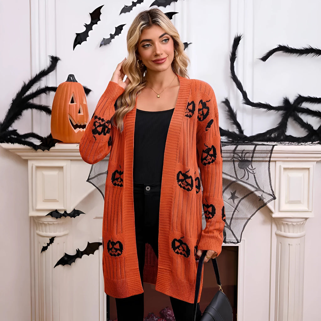 Women's black Halloween cardigan with orange Jacquard knitted pumpkin head pattern, shown on a hanger.