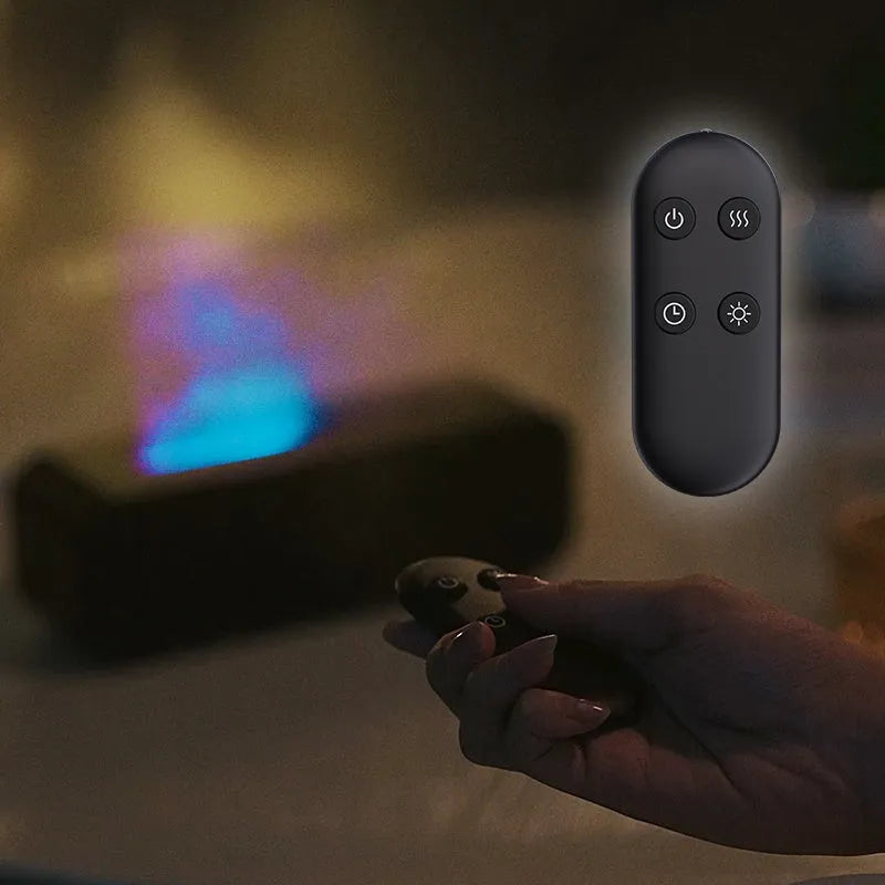 Black Flame Dynamic aroma diffuser with flickering light effect and remote control on a table.