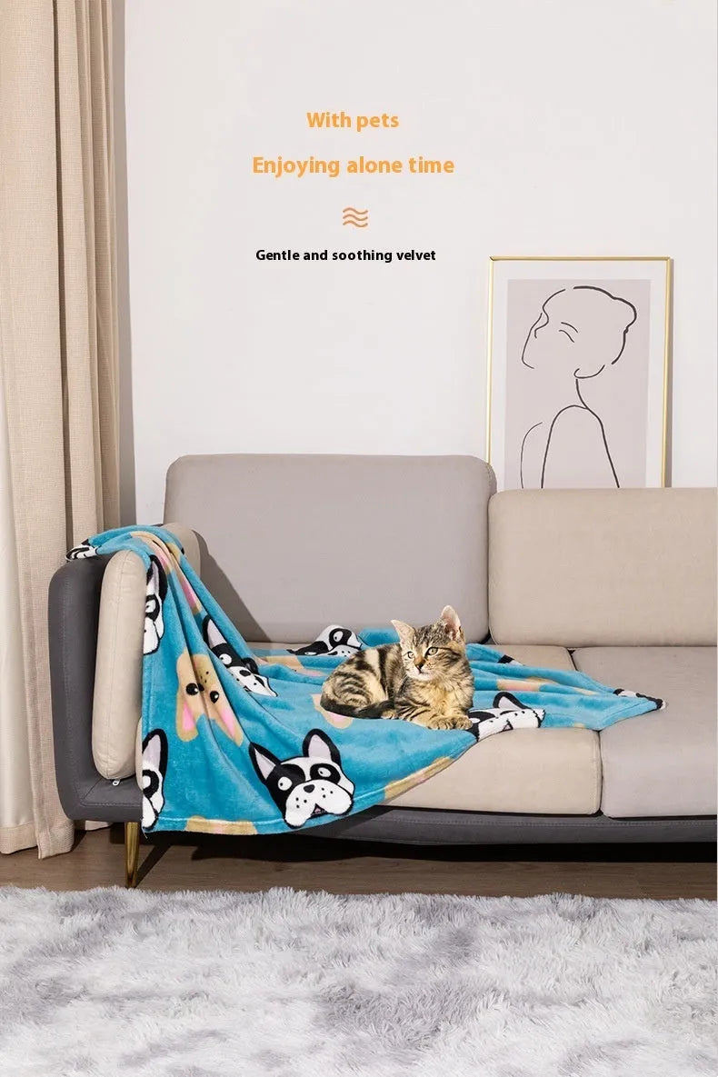 Blue cartoon dog pattern double-sided flannel pet blanket shown on a dog bed.