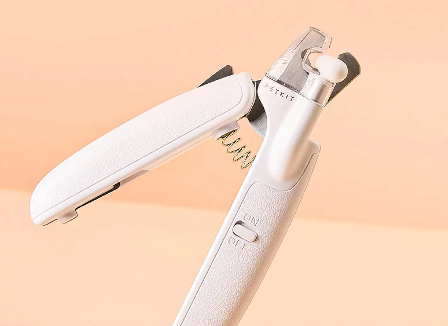 White LED pet nail clipper with transparent splash guard and triangular blade for cats and dogs