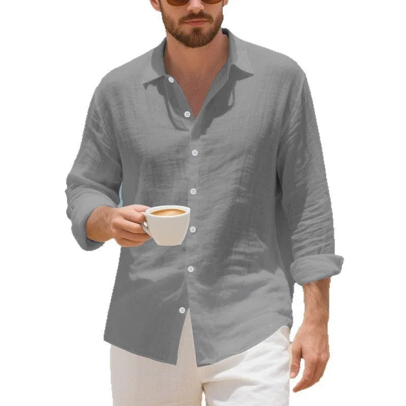 A man's loose-fit linen Hawaiian casual shirt in an earthy colour on a hanger.