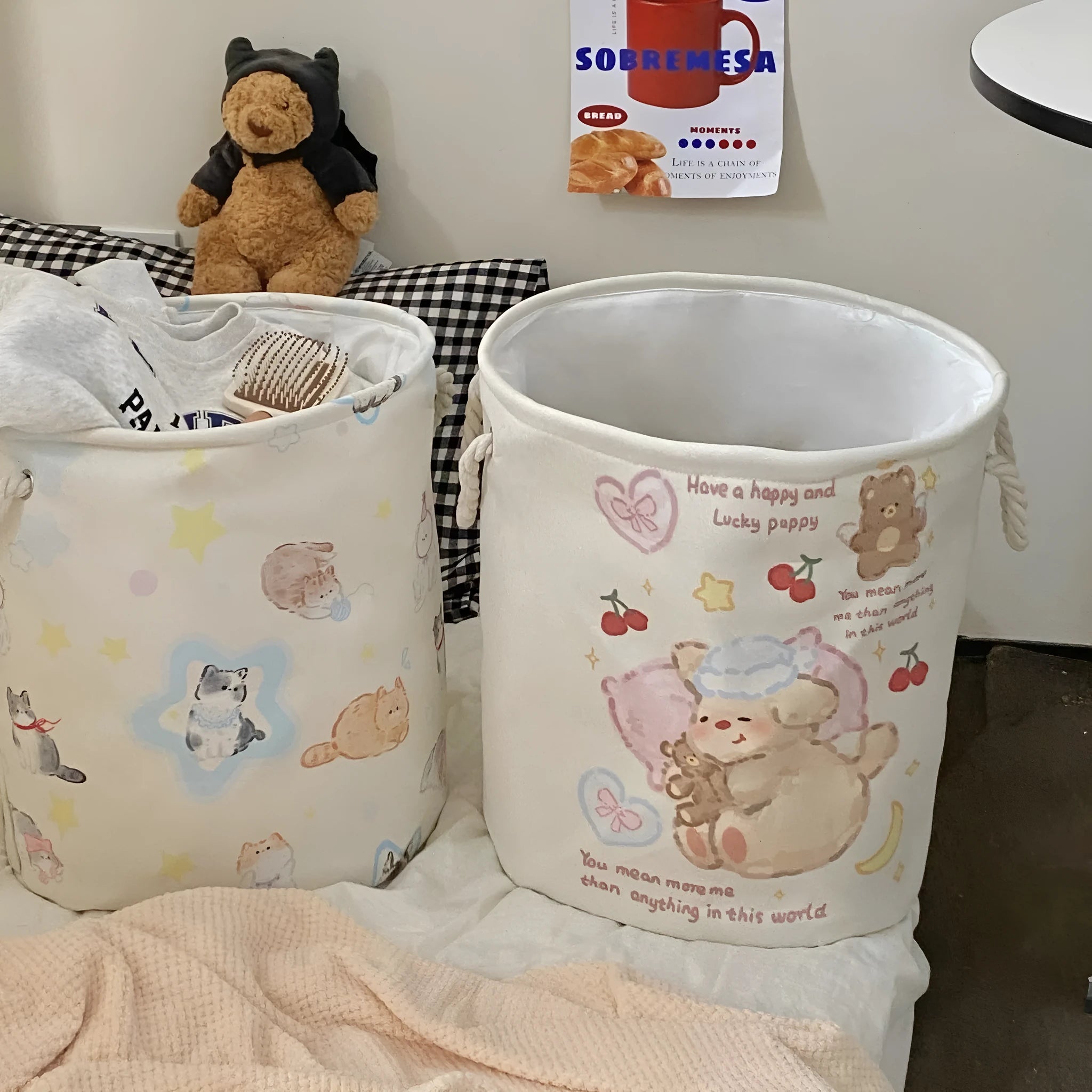 Foldable cotton laundry basket featuring an illustrated design, shown in a bedroom setting.
