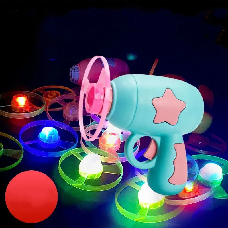 LED light-up flying saucer toy set with launcher gun, three glowing discs, and target board.