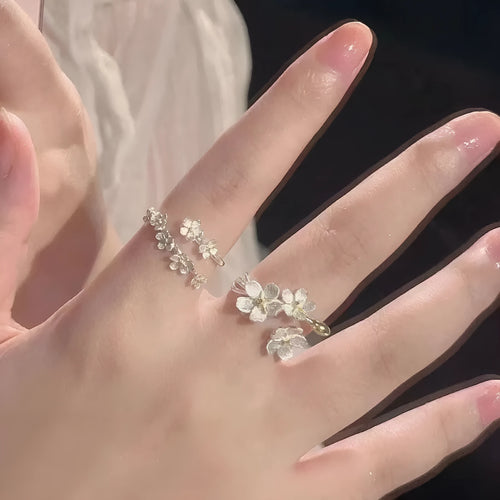 3D jasmine flower adjustable ring in zinc alloy with electroplated finish on a hand.