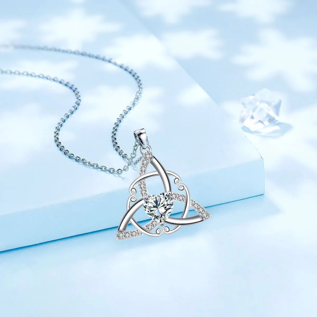 Geometric Celtic knot necklace pendant in copper with electroplated finish showing colour options