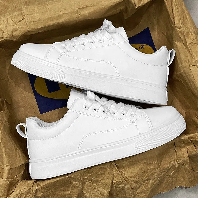 Men's low-top casual sneakers in black, white, or black with white bottom, showing round toe and flat rubber sole.