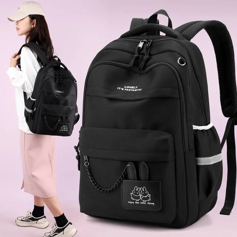 Nylon school backpack 30x21x43cm with letter pattern, available in pink, black, orange, and purple.
