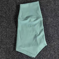 Women's high-waist nylon yoga shorts in various colours for moisture-wicking during exercise