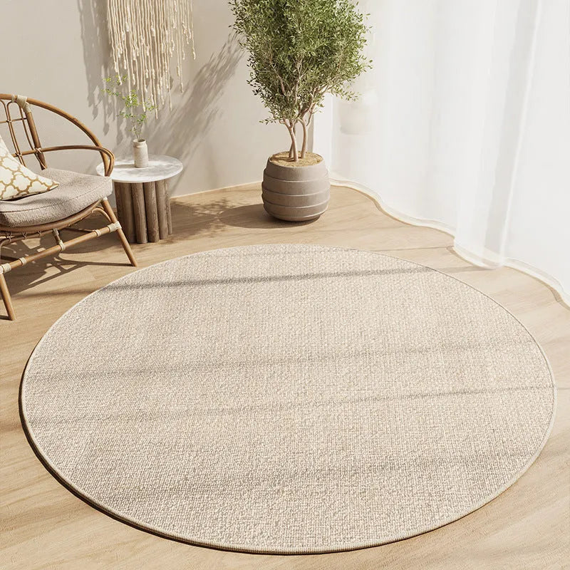 Simple round carpet in modern geometric pattern on floor under desk with swivel chair