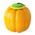 Orange pumpkin-shaped dog chew toy with squeaker for small dogs on green background