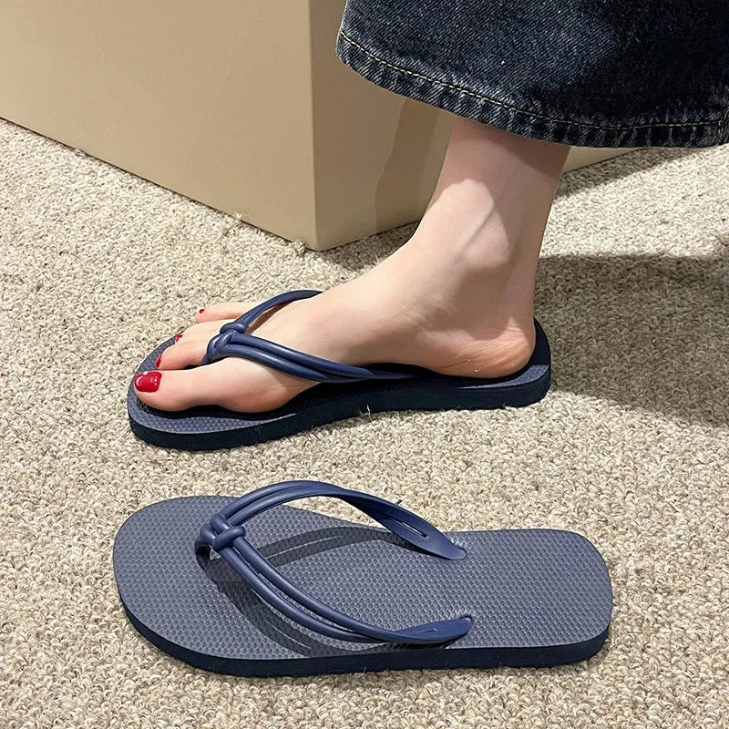 PVC toe-covering flip flops for men on a plain background showing colours and injection-moulded sole.