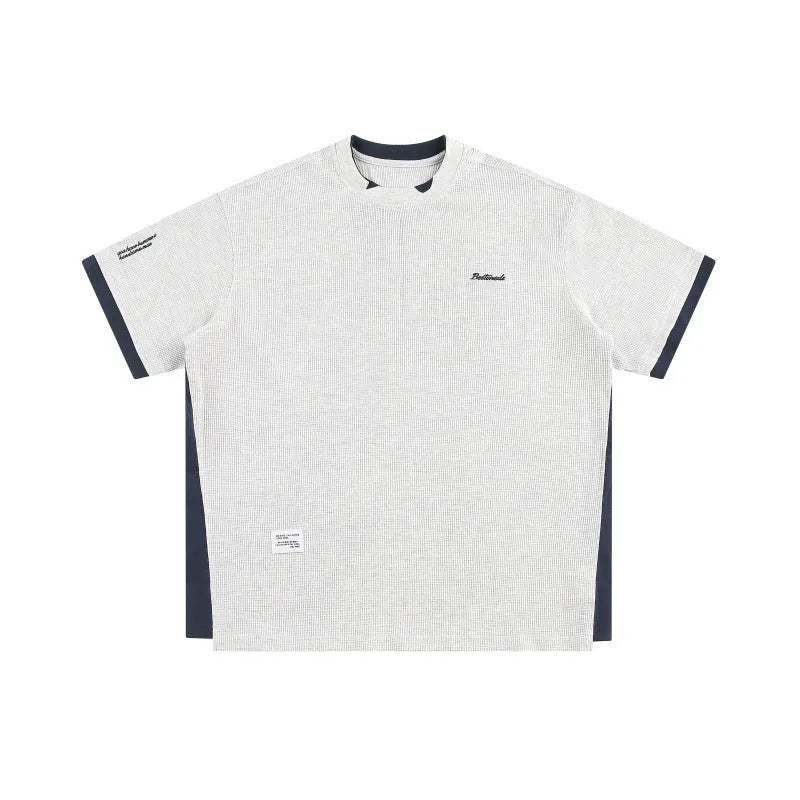 Loose fit grey waffle knit t-shirt with retro alphabet embroidery on the front.