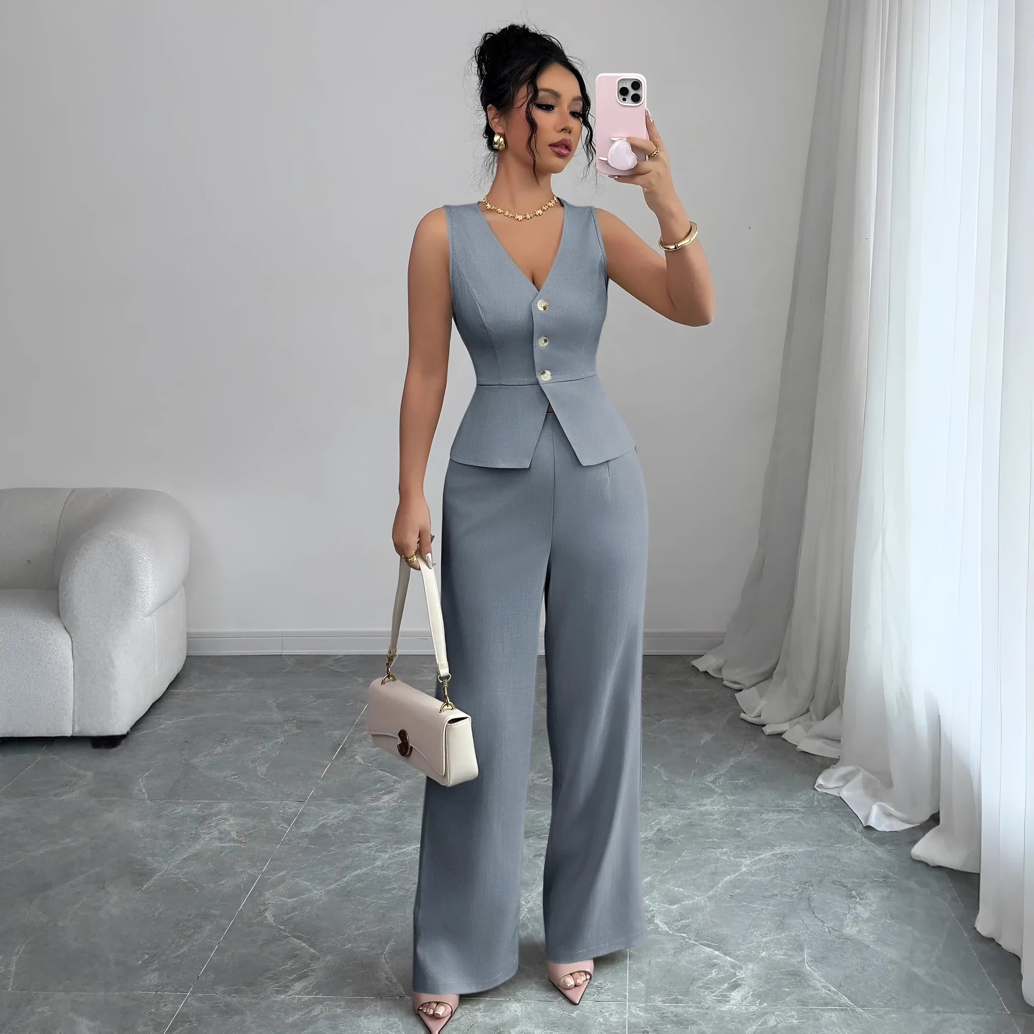 Women's sleeveless vest and high-waist trousers two-piece set in solid colour polyester fabric.