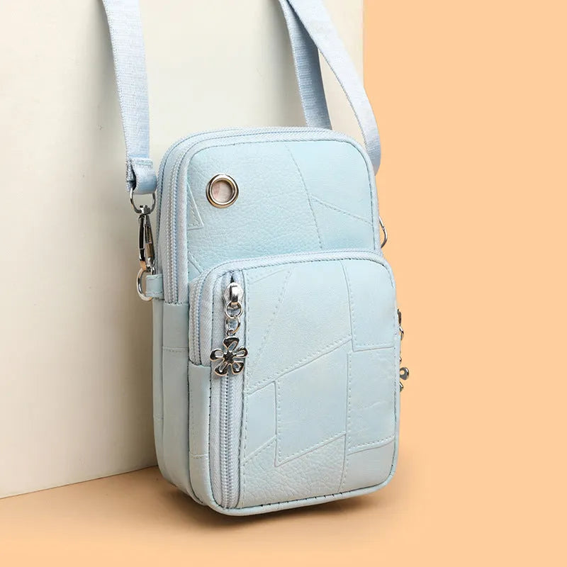 Vertical square mini mobile phone bag in PU leather with an exterior sandwich pocket.