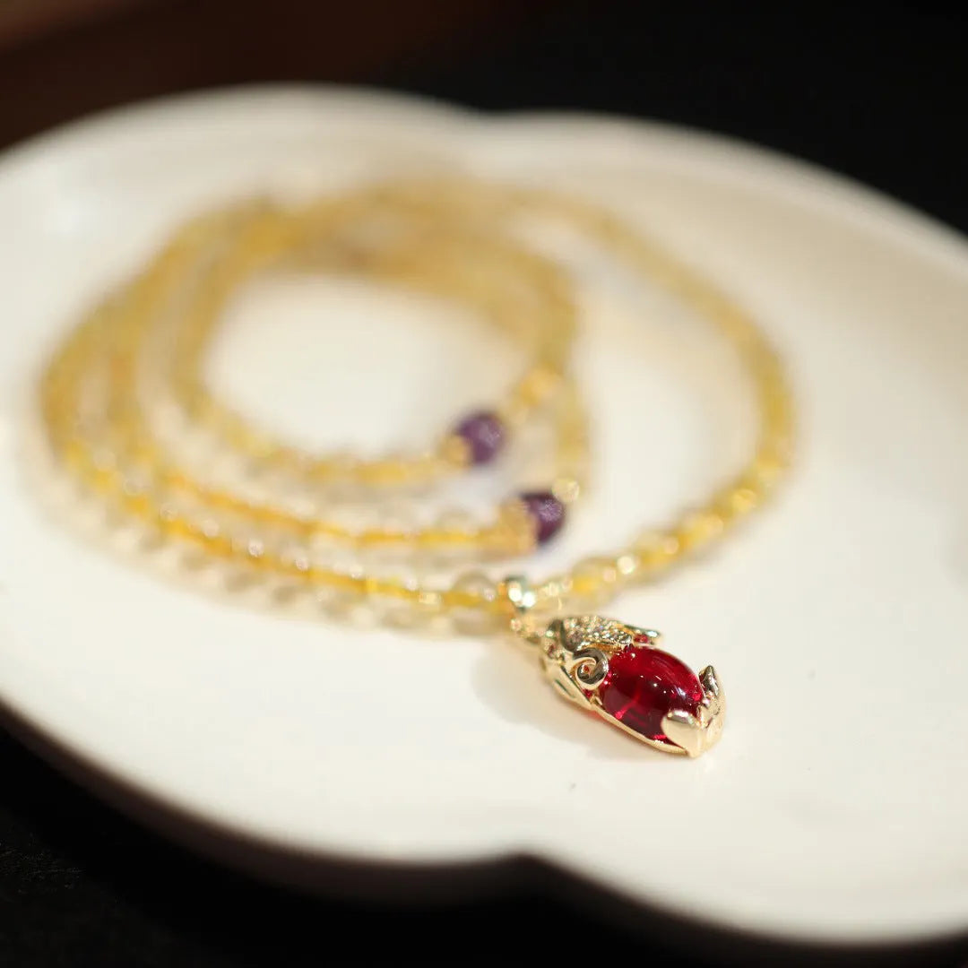 Gold rutilated quartz bracelet with three circles design and hanging chopsticks on wrist