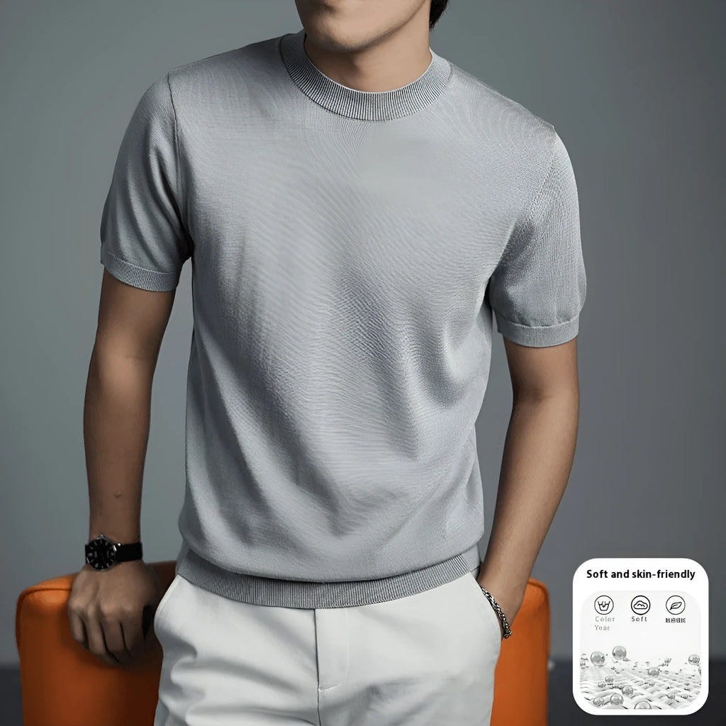 Man wearing a silver grey knitted round neck t-shirt with short sleeves.