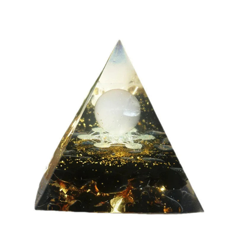Small 6cm clear epoxy resin pyramid ornament with embedded pieces of natural coloured crystal gravel.