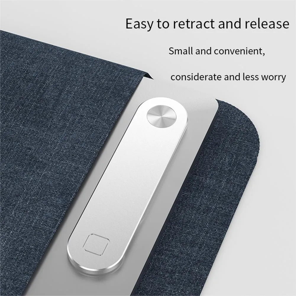 Black aluminium magnetic phone holder attached to side of silver laptop