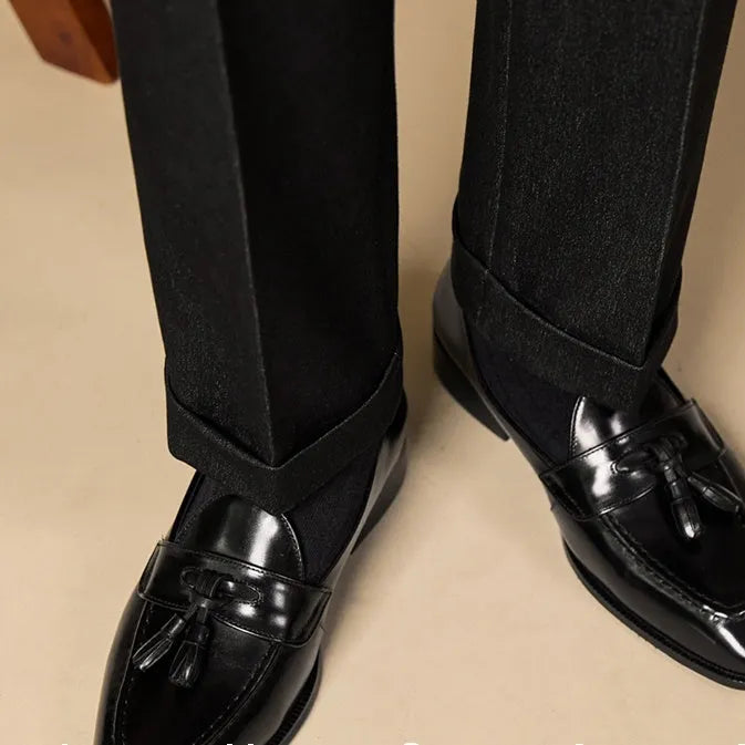 Black and brown business casual loafers with tassel detail and genuine leather upper