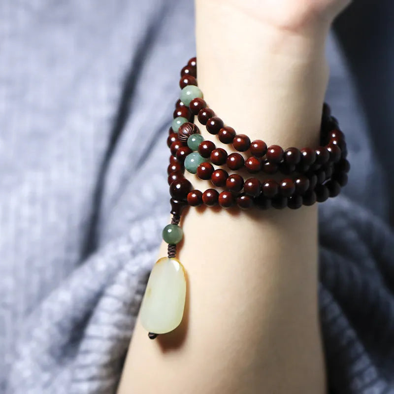 Rosewood bead bracelet with a carved wooden pendant, shown in Indian and Zambia rosewood colour options.