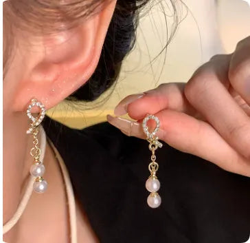 A pair of copper floral earrings with S925 silver needle in A1653 gold colour on a white background.