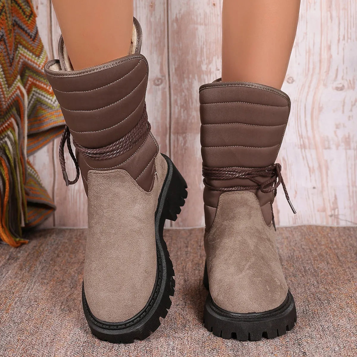 Women's black chunky heel snow boots with lace-up front and fleece lining.
