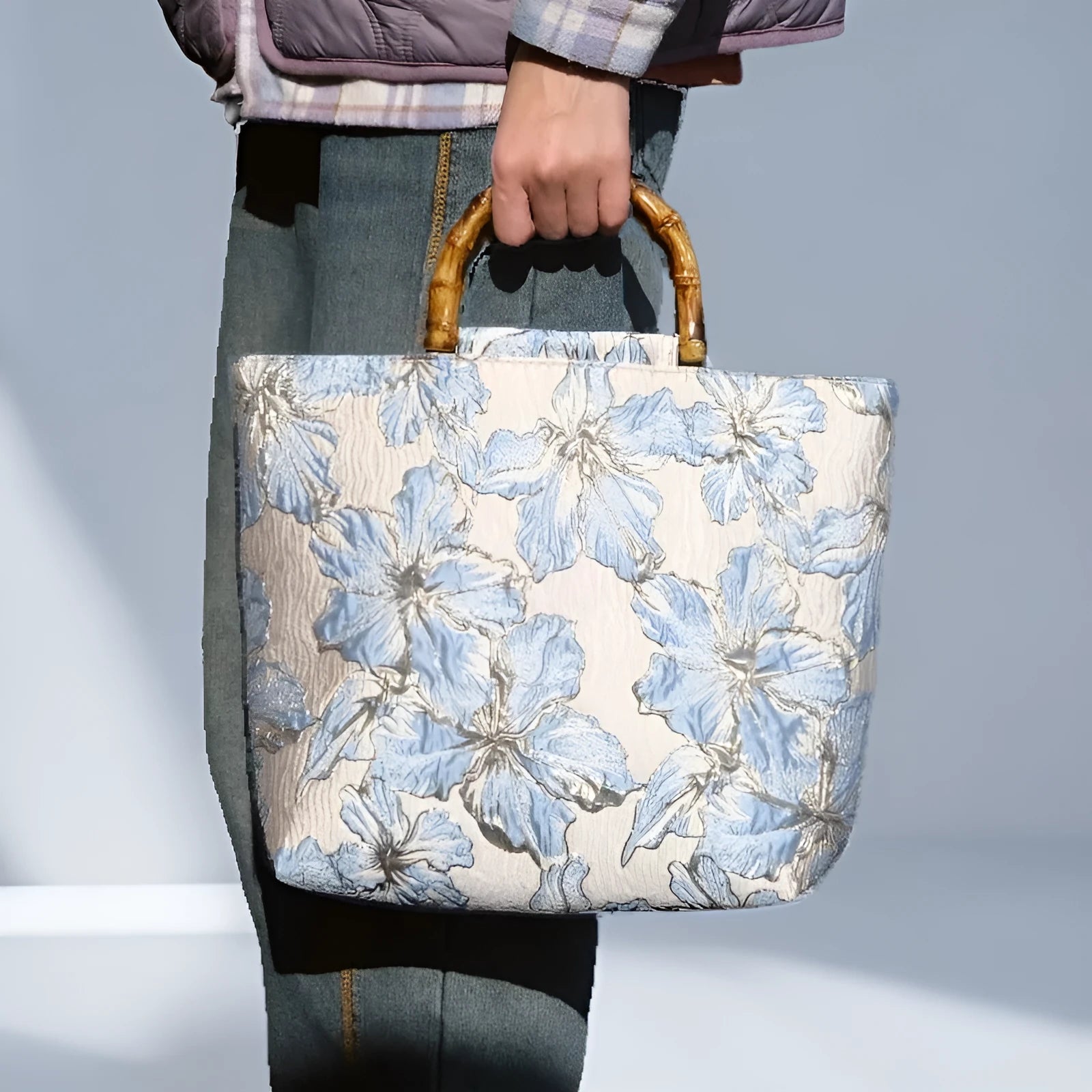 Light blue square canvas shoulder bag with bronzing flower detail and double strap connectors
