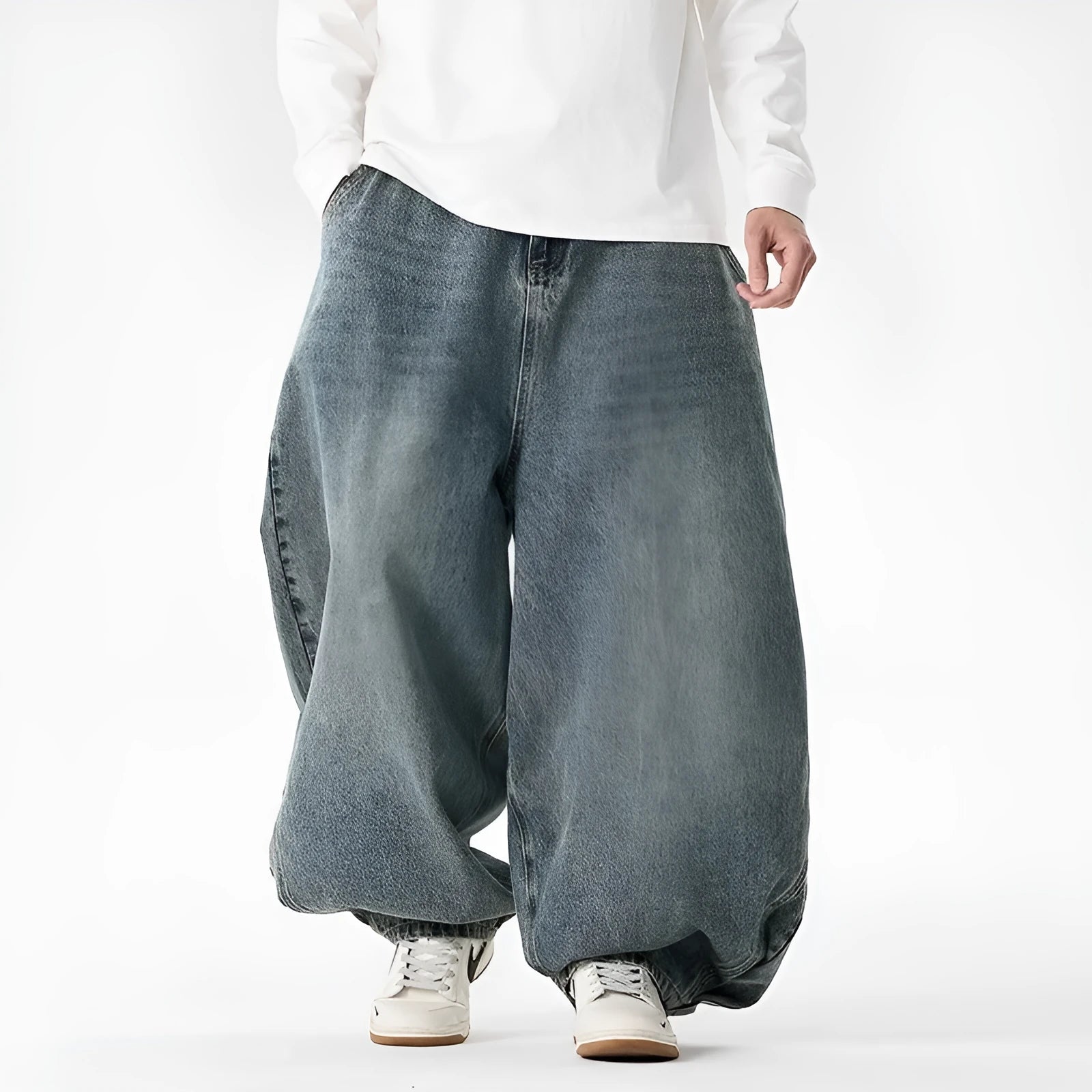 Men's plus-size baggy blue denim jeans with straight leg and low waist on a neutral background.