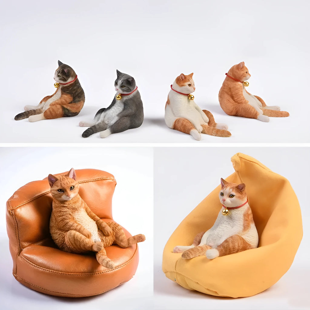 Small lazy cat figurine on a sofa, a 7.5cm high resin car dashboard ornament.