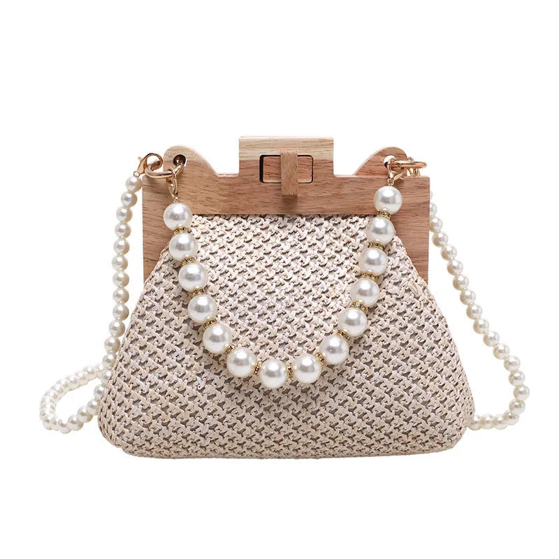 Women's straw woven shoulder bag with pearl chain strap and multiple internal compartments in horizontal square shape